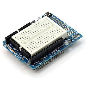 Arduino Uno Proto Shield With Syb-170 Mini Breadboard - blue circuit board featuring a white mini breadboard, black pin headers, and a reset button.