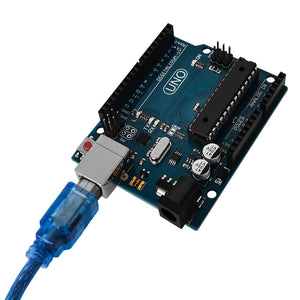 Arduino Uno R3 - a blue circuit board with a USB cable connected to the port, featuring digital and analog pin headers and a power jack.
