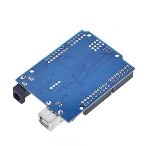 Arduino Uno R3 SMD Board Kit Without USB Cable - the bottom side of the blue rectangular circuit board with a USB-B port and a DC power jack.