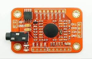 Arduino Voice Recognition Module V3 - an orange rectangular circuit board featuring a black audio jack, a central circular sensor, and various pin headers.