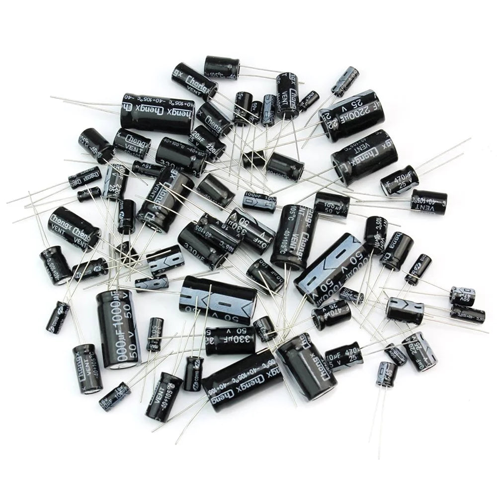 Assorted Commonly Used Values Capacitors Pack Electrolytic - a scattered collection of black cylindrical electrolytic capacitors with metal leads.