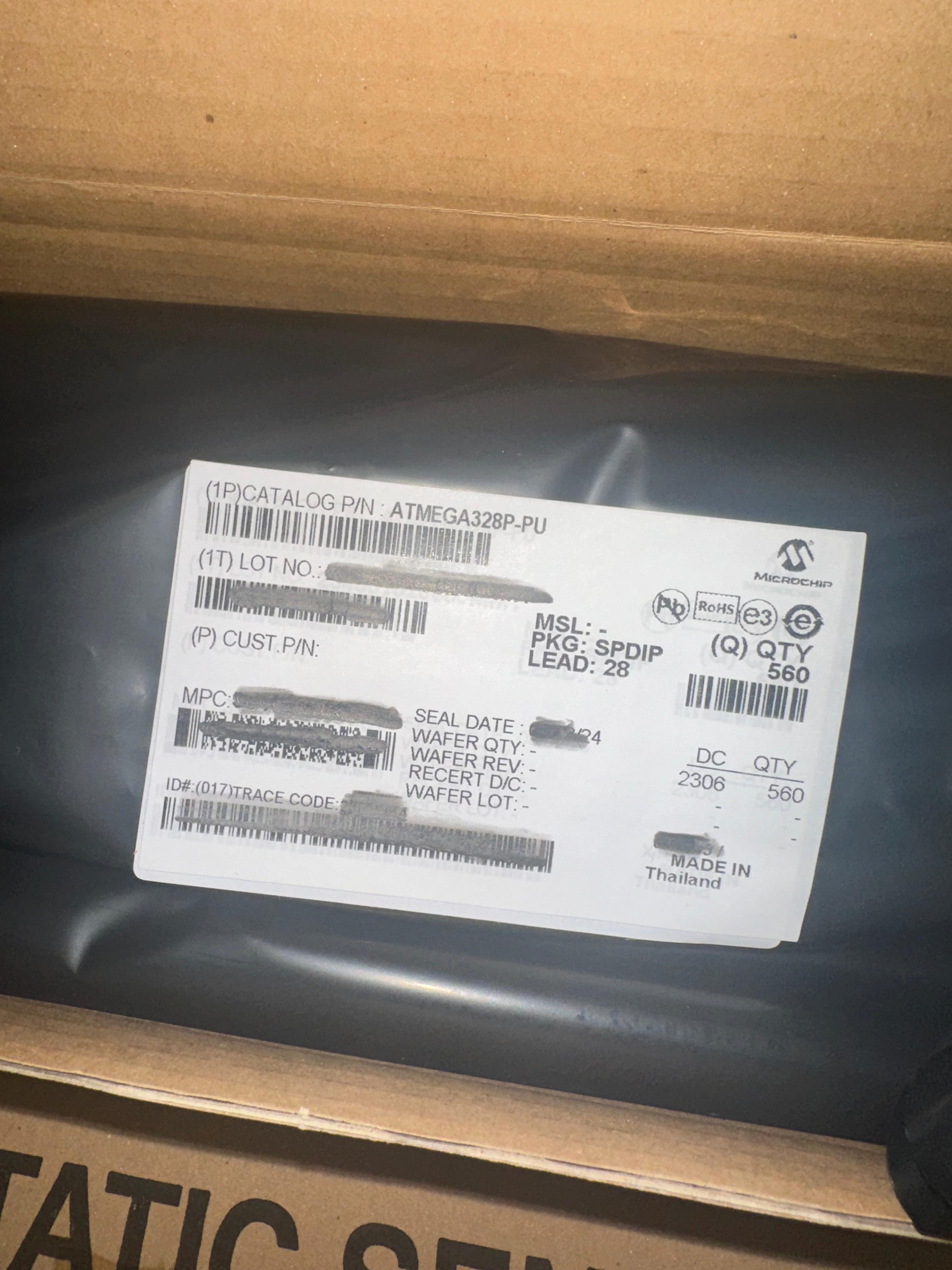 ATMEGA328P-U Microcontroller | High-performance MCU | Digilog.pk - shown as a bulk quantity of 560 units inside a sealed black anti-static bag with a Microchip product label.