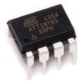 Atmel ATTINY85 (Attiny-85 / ATTINY85-20PU) – High-Performance Microcontroller for Compact Embedded Solutions - an 8-pin black integrated circuit chip with silver metal legs, shown in a close-up angled view.