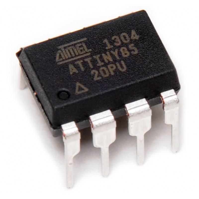 Atmel ATTINY85 (Attiny-85 / ATTINY85-20PU) – High-Performance Microcontroller for Compact Embedded Solutions - an 8-pin black integrated circuit chip with silver metal legs, shown in a close-up angled view.