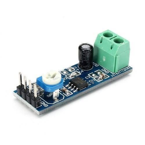 Audio Amplifier Module LM386 5-12V 10k Adjustable Resistance - a blue circuit board with a white potentiometer, a black capacitor, and a green terminal.