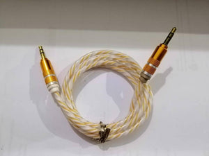 Aux Cable - a coiled, transparent cable with yellow internal wiring and gold-coloured 3.5mm jack connectors on both ends.