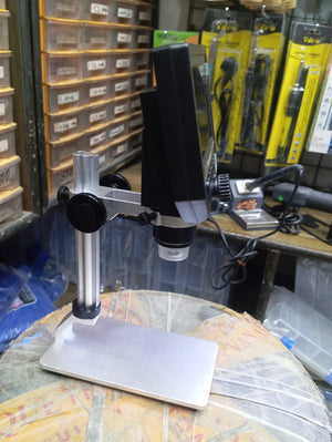 AXS-G600+ 4.3 Inch Screen 600x Zoom Microscope - shown in profile on a silver metal stand with a black display screen, focus knobs, and lens.