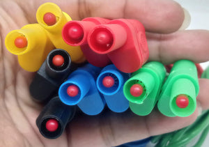 Banana Clip Wires 4mm | High-Quality Test Leads | Digilog.pk - a close-up of a hand holding a bundle of multi-coloured red, yellow, black, blue, and green 4mm banana plug connectors.