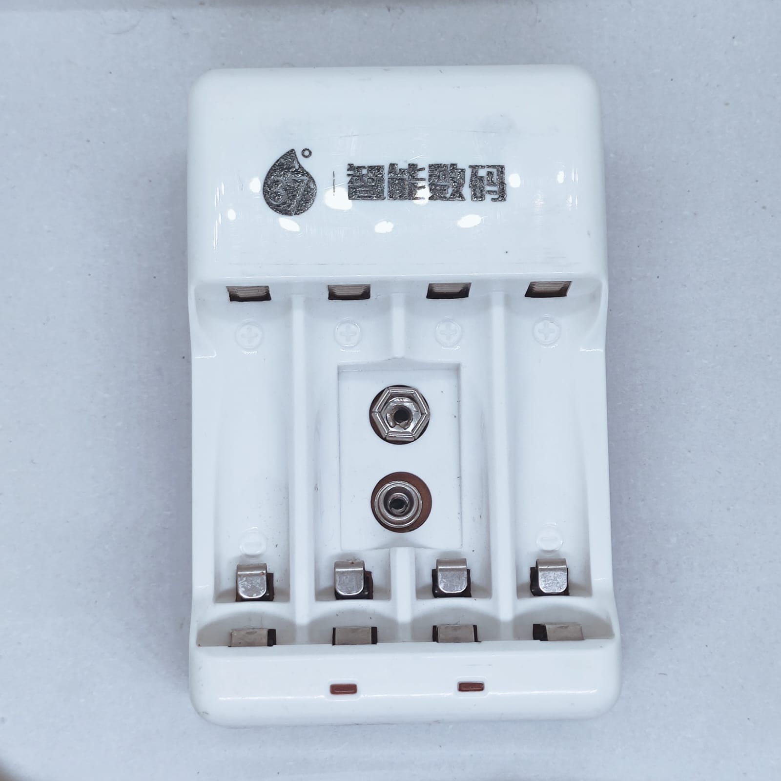Battery Charger With Discharge Function For AA, AAA, 9V DC 20mA Rechargeable Batteries - white four-slot charging unit with two 9V battery terminals.