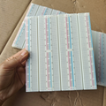 Big bread board - a large white rectangular prototyping board with multiple columns of numbered holes and red and blue power rails, held in a hand.