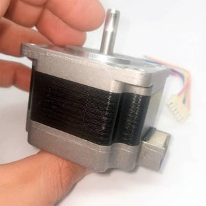 Bipolar NEMA23 1A Stepper Motor 4 Wire Stepper Motor - shown held in a hand, featuring a silver metal body, a protruding drive shaft, and a white four-pin connector cable.