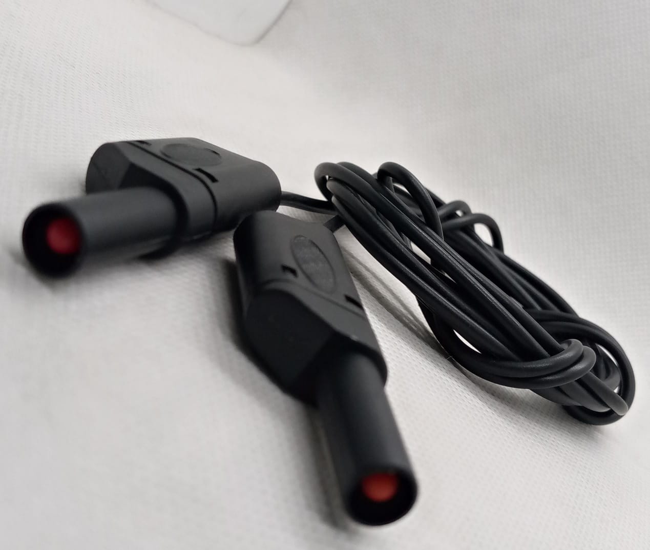 Black Banana Clip Wires 2 Meter | High-Quality Test Leads | Digilog.pk - two black test leads with red-tipped connectors and a coiled black cable against a white background.