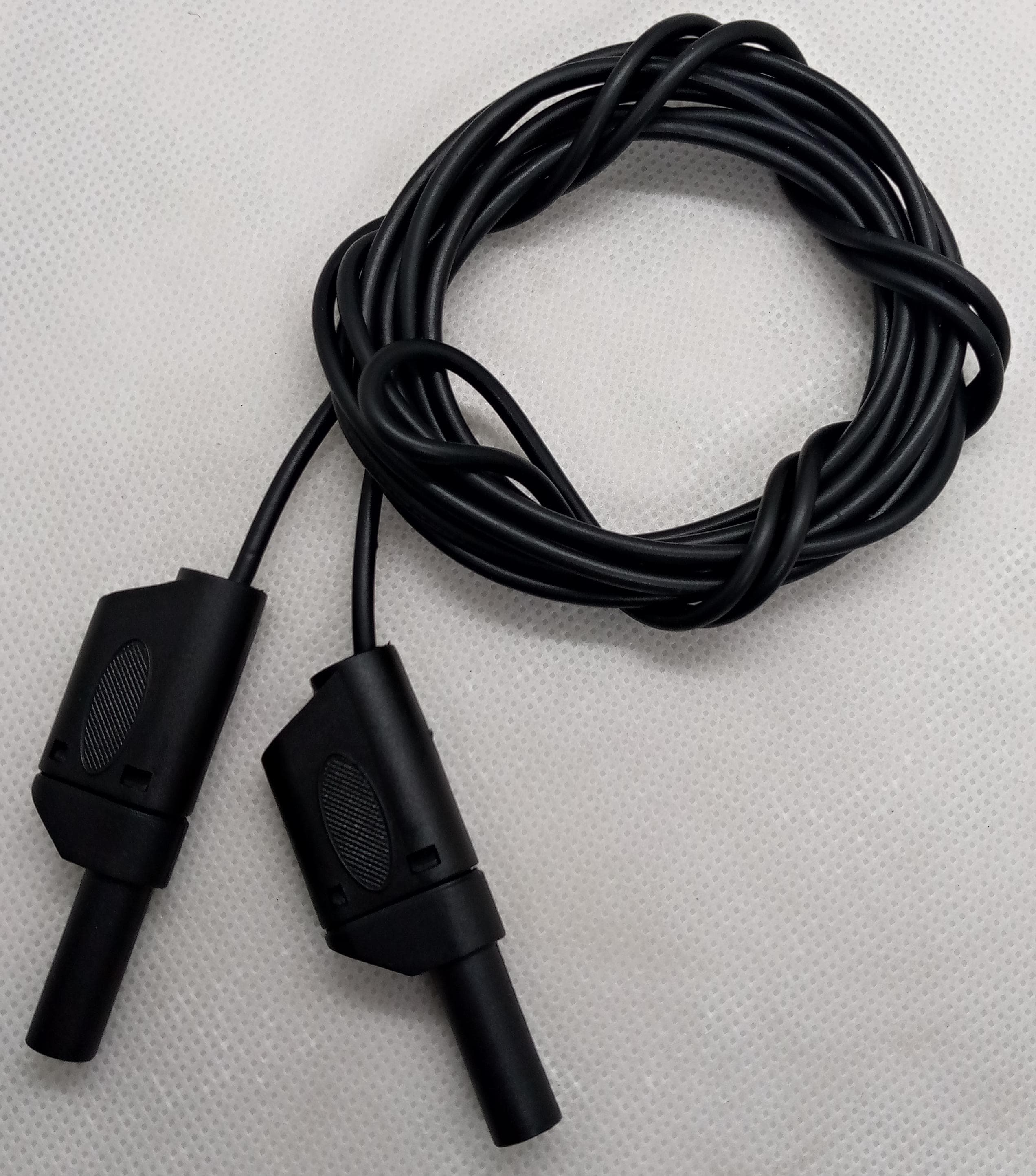 Black Banana Clip Wires 2 Meter | High-Quality Test Leads | Digilog.pk - a coiled black cable with two black banana plug connectors on a white background.