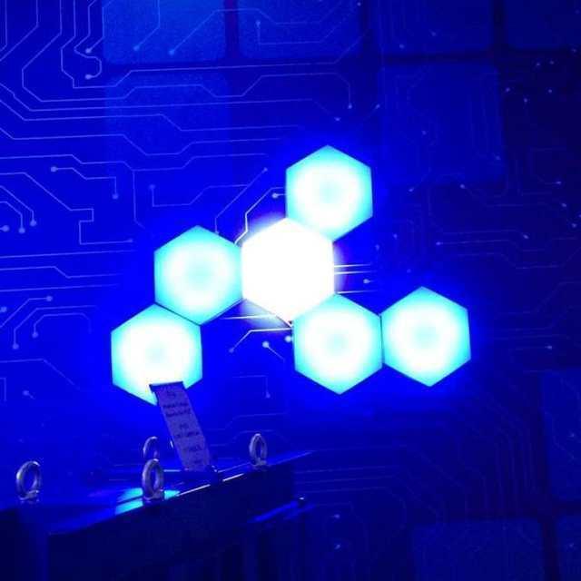 Blue Touch Light Wall Mount Magnetic Modular (1pc) - five illuminated hexagonal panels mounted on a wall with a circuit board pattern background.