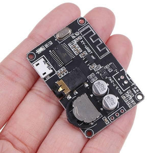 Bluetooth 5.0 Audio Receiver Board-controllable Volume - a black circuit board with a micro-USB port, audio jack, volume knob, and antenna trace.
