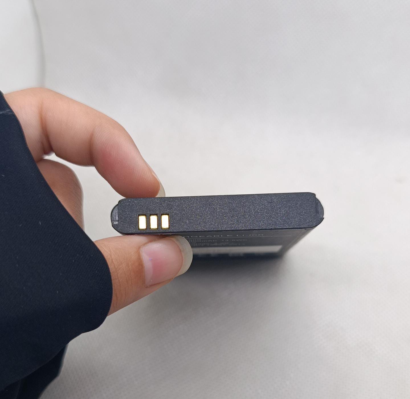 BM5500 3.7V 4000mA Battery - a close-up view of the black rectangular battery showing three gold-plated electrical contact pins on the side.