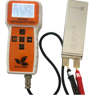 BP2080 Rv Meter Slcd Battery Internal Resistance Tester - the orange and white handheld device with a screen reading 1.329mΩ and 3.8479V testing a battery.
