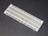 Breadboard MB102 830 Point Clear -transparent - a rectangular, clear plastic breadboard with 830 connection points and red and blue power rails.