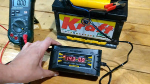 Car Charger Portable Car Battery Charger With Digital Display (SON-1206D) - connected to a car battery showing 14.3 volts on its digital display.