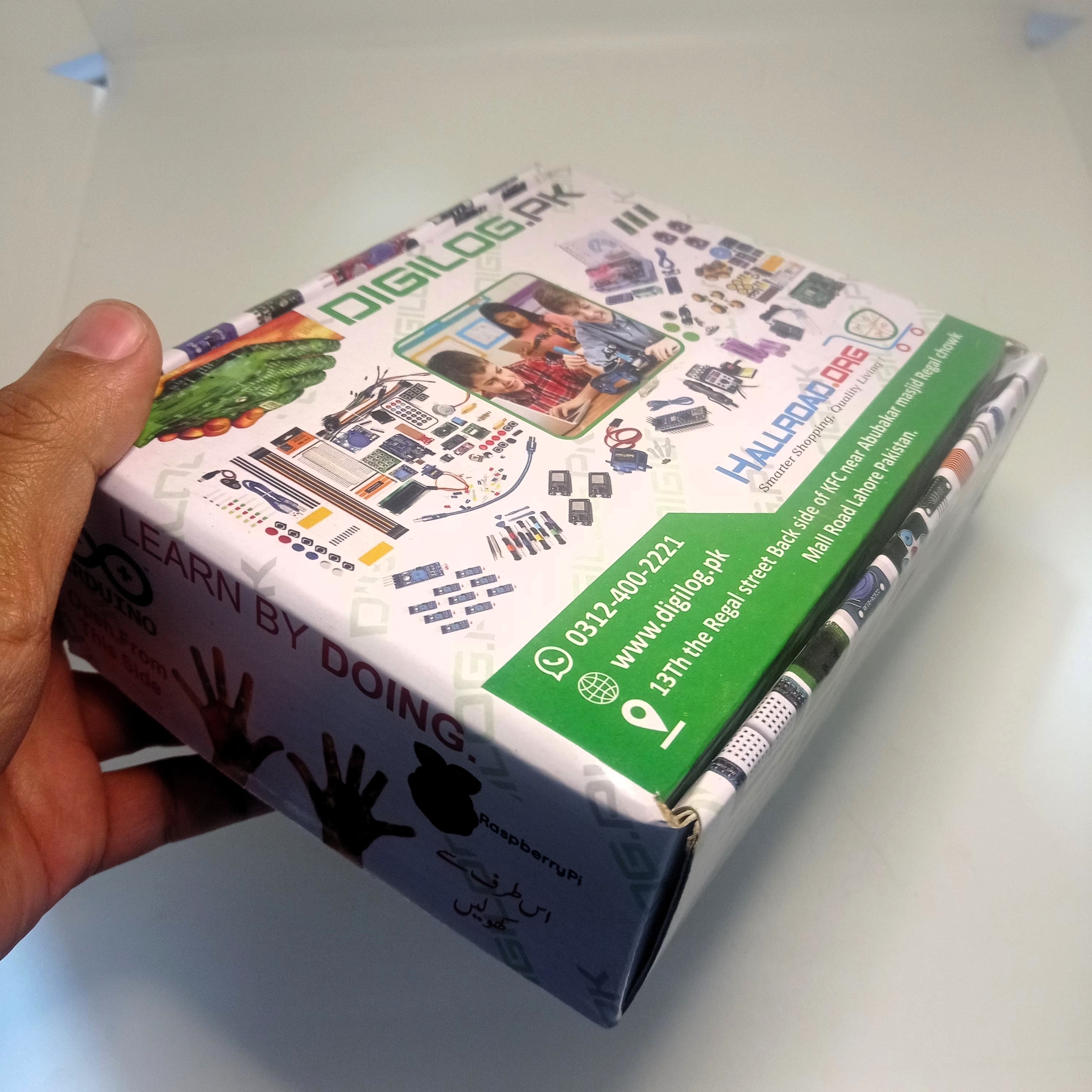 Carboard Box For STEM Kit - a white rectangular box with printed graphics of electronic components, contact information, and the Digilog.pk logo.