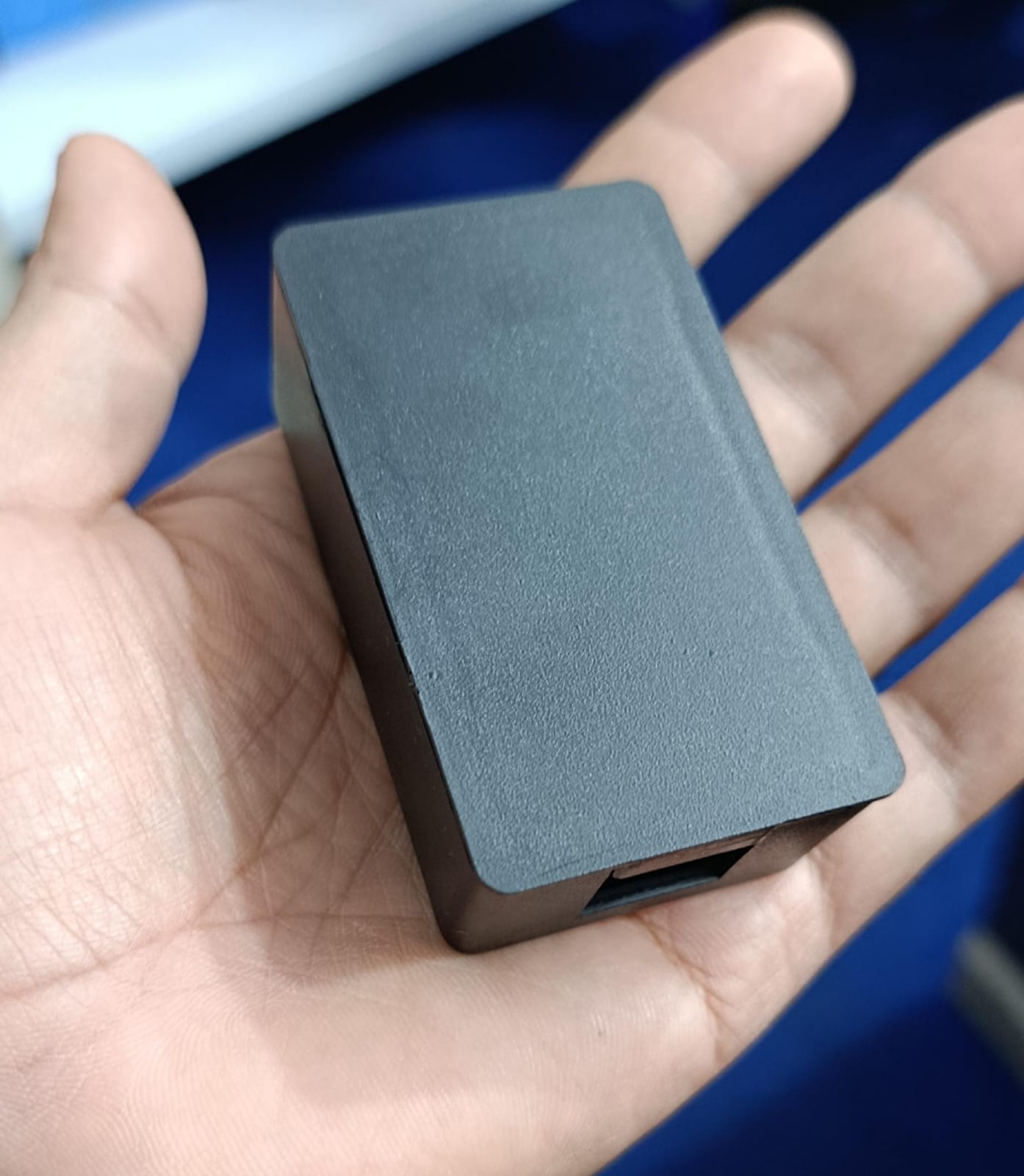 Casing For Inverterzone WiFi Dongle - shown as a plain, rectangular black plastic housing held in a hand, featuring a single visible port opening.