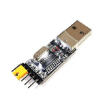 CH340G USB To TTL(serial) Converter For Arduino Nano Raspberry Pi - a black circuit board with a silver USB-A connector on one end and four male header pins with a yellow jumper on the other.