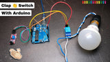 Clap Switch Using Arduino Uno | Parts Only - a blue Arduino Uno connected to a sound sensor module and a relay module, which is wired to a white light bulb.