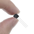 Clone LM35 Cheap Version - a black, three-pin electronic component held between two fingers, with "9100J LM35 DZ" printed on its surface.