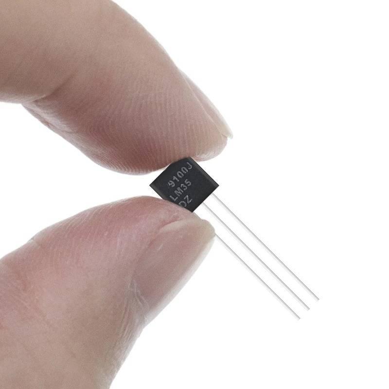 Clone LM35 Cheap Version - a black, three-pin electronic component held between two fingers, with "9100J LM35 DZ" printed on its surface.