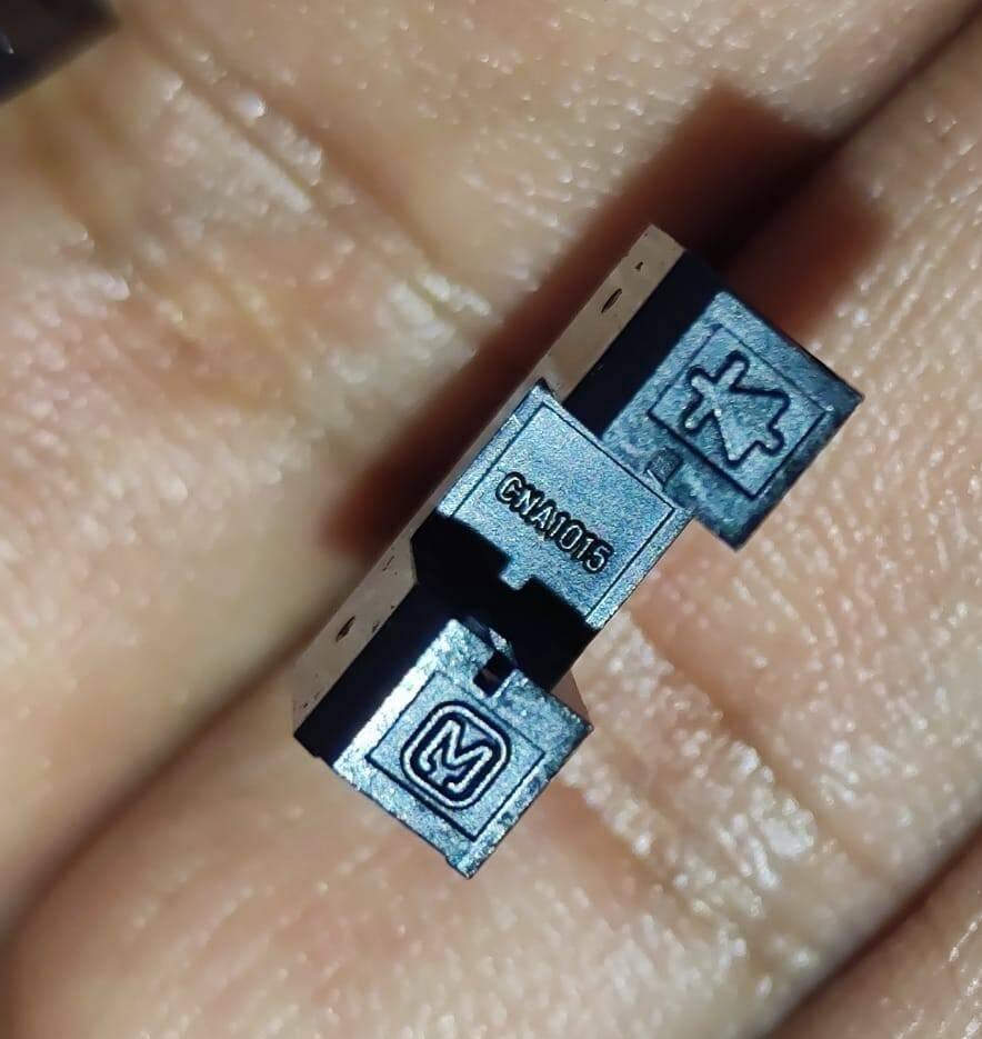CNA1015 Japan IR u Type Sensor IR Sensor Slot Sensor IR Cut Sensor Photo Interrupter - a close-up view of the small black U-shaped photo interrupter component showing the model number and brand logo printed on its side.
