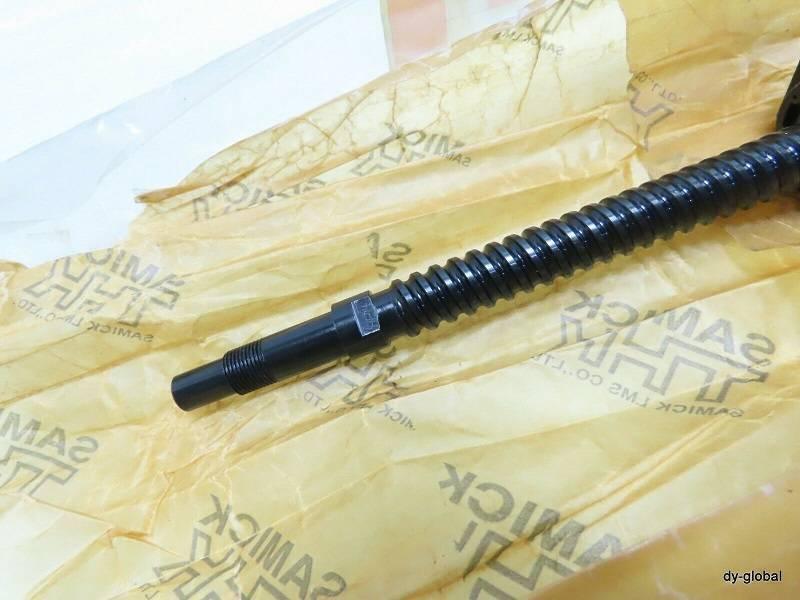 CNC Ball Screw - a close-up of a long, black, threaded metal rod resting on branded yellow protective paper.
