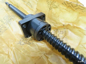 CNC Ball Screw - a black metal threaded rod with a square mounting flange and ball nut, resting on branded yellow protective paper.