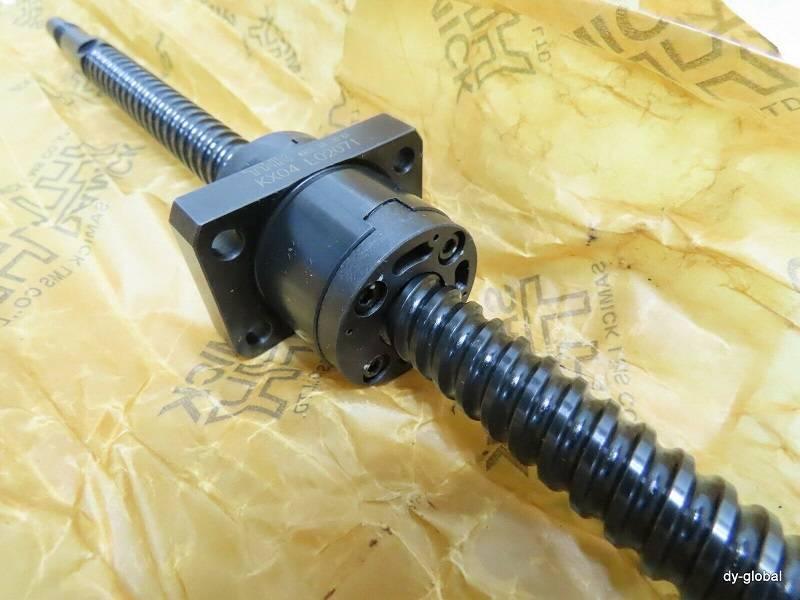 CNC Ball Screw - a black metal threaded rod with a square mounting flange and ball nut, resting on branded yellow protective paper.