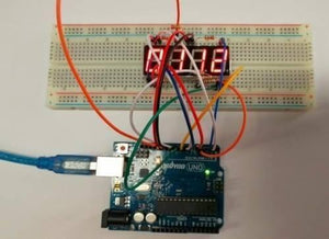Common Anode 4 Digit 7 Segment Red LED Display - connected to an Arduino Uno on a breadboard, showing the numbers 8, 3, 7, and 2 on the screen.