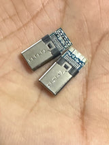 Connector USB 3.1 Type C Connector 16 Pin Male Socket - two silver and blue metal male connectors resting on a palm.