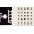 Copy DHT22 Digital Temperature And Humidity Sensor Module - a white plastic sensor housing mounted on a black PCB with three output pins.