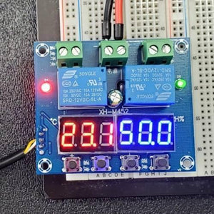 Copy / Fake Incubator Temperature Humidity Controller DC 12V Xh M452 - a blue circuit board with two relays, four buttons, and active red and blue displays.