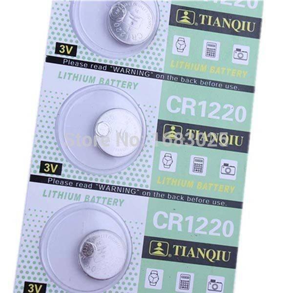 CR1220 Coin Cell - shown as a strip of three silver button batteries in their original green and white blister packaging.