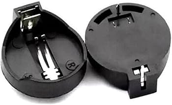 CR2032 Coin Cell Battery Holder - two black plastic circular battery holders with metal contact pins, one viewed from the top and one from beneath.