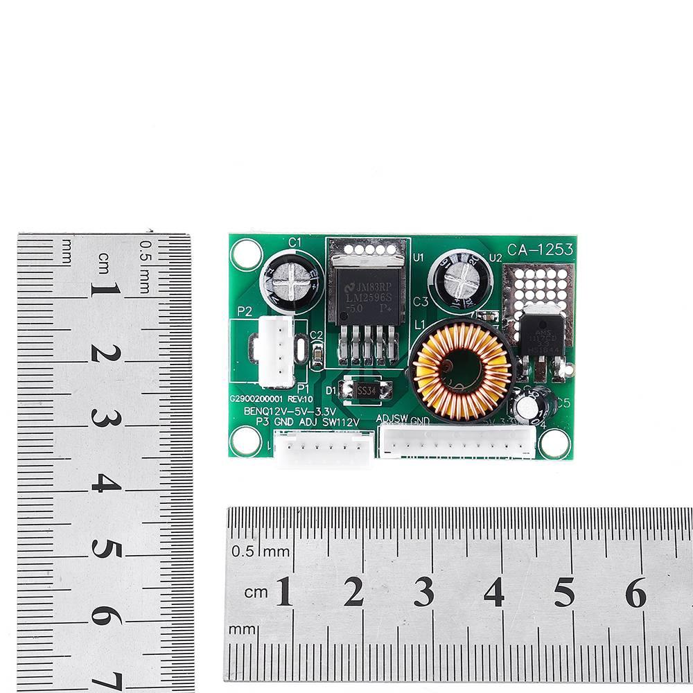 D120533V 12V DC Step Down Convertor Module CA1253 DC To DC Buck Converter - shown on a white background next to two metal rulers to indicate its dimensions.
