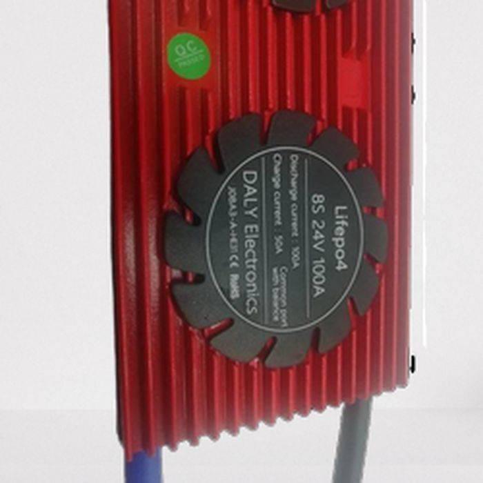 Daly BMS 8s 24V 100A LiFePO4 Battery Protection Module PCB Protection Board With Balance - a red rectangular unit with a circular black label showing specifications and a green QC sticker.