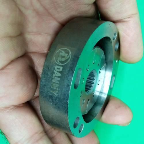Danny Pump Cartridge 34079623001 - a close-up of the metallic circular pump component held in a hand, showing the splined center and side bolt holes.