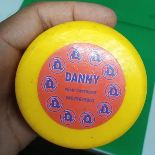 Danny Pump Cartridge 34079623001 - a close-up of a round, yellow plastic object with a circular red label in the center featuring the brand name and code.