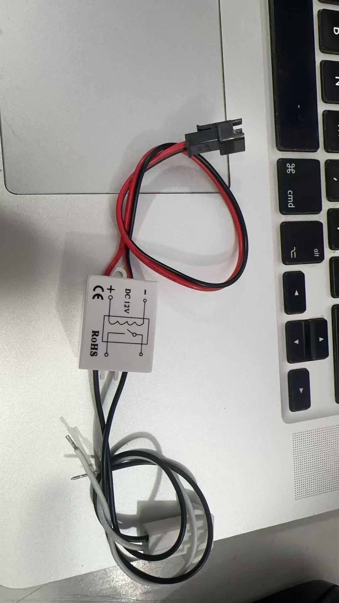 DC 12V Mini Relay Controller For Mirror Defogging Film Anti-fog Lamp On-off Control High Power 500W Contact Load - a white square housing with a wiring diagram, a red and black wire with a connector, and two loose wire leads.