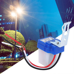 DC 12V Photocell Sun Switch Automatic On/off Light Control Sensor Switch 10A Day Night Sensor Switch For Lights - a blue and white light sensor with a metal mounting bracket and three exposed red, black, and white wire leads.