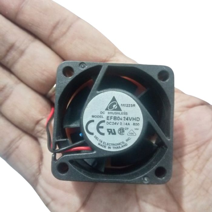 DC 24V 0.14A, 40x40x20mm EFB0424HD Delta Fan - a black 40mm square DC brushless cooling fan held in a hand, showing the circular label with model and electrical specifications.