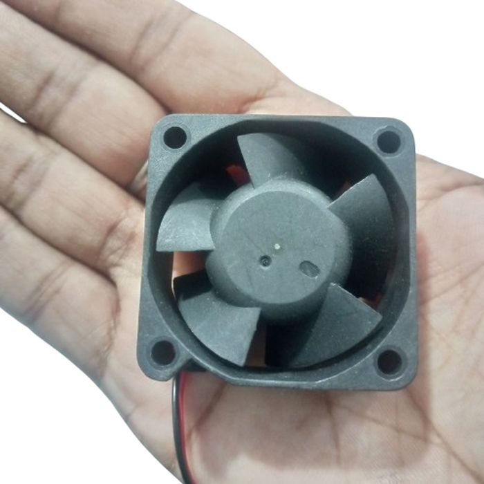 DC 24V 0.14A, 40x40x20mm EFB0424HD Delta Fan - a small black square DC cooling fan with a five-blade rotor held in a person's hand.