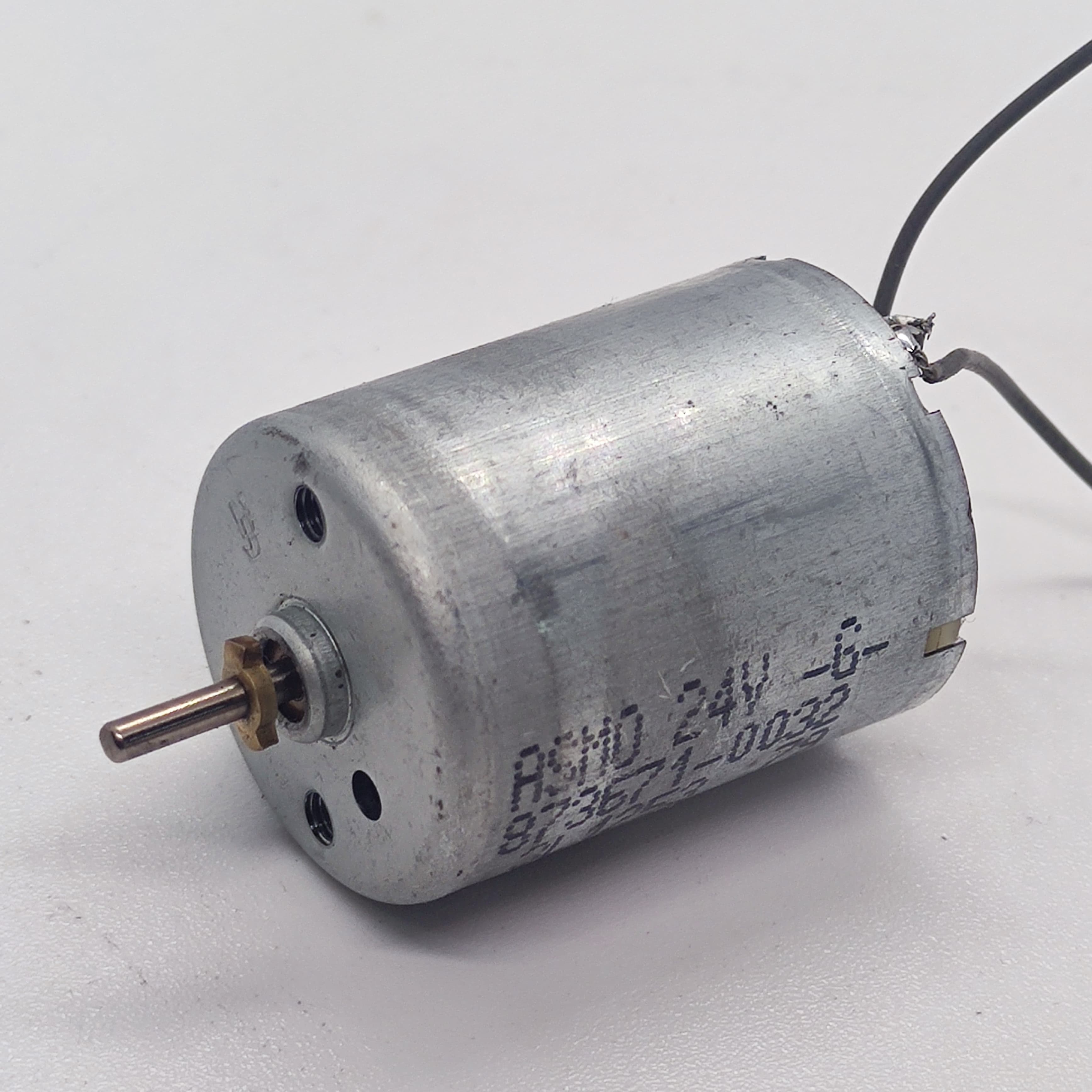 DC 2V To 24V 5100 RPM High Torque Mini Micro Motor DC Motor - a cylindrical silver metal DC motor with a small brass gear on the shaft and two wire leads.