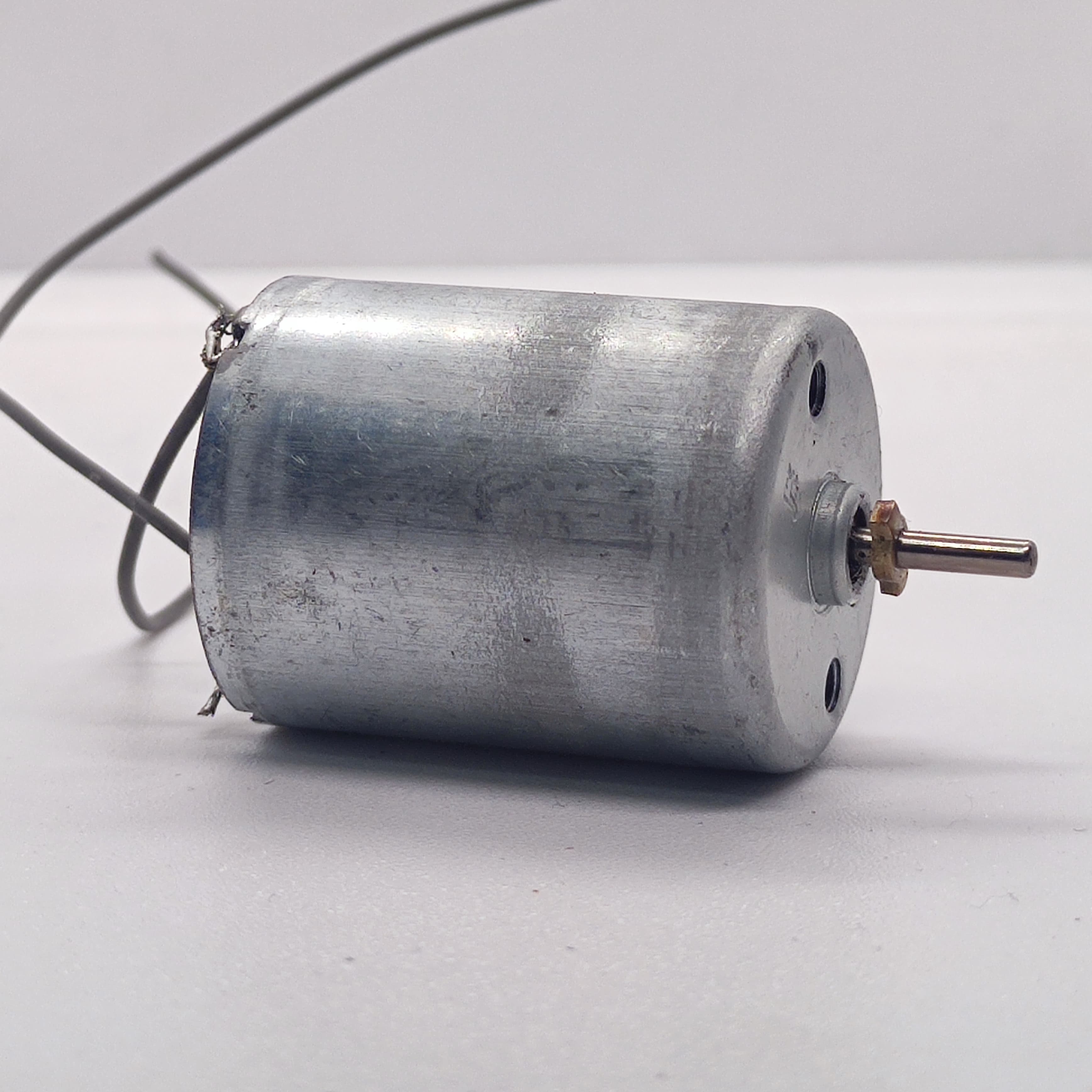 DC 2V To 24V 5100 RPM High Torque Mini Micro Motor DC Motor - a silver cylindrical DC motor with a small metal shaft and two thin wire leads attached to the back.