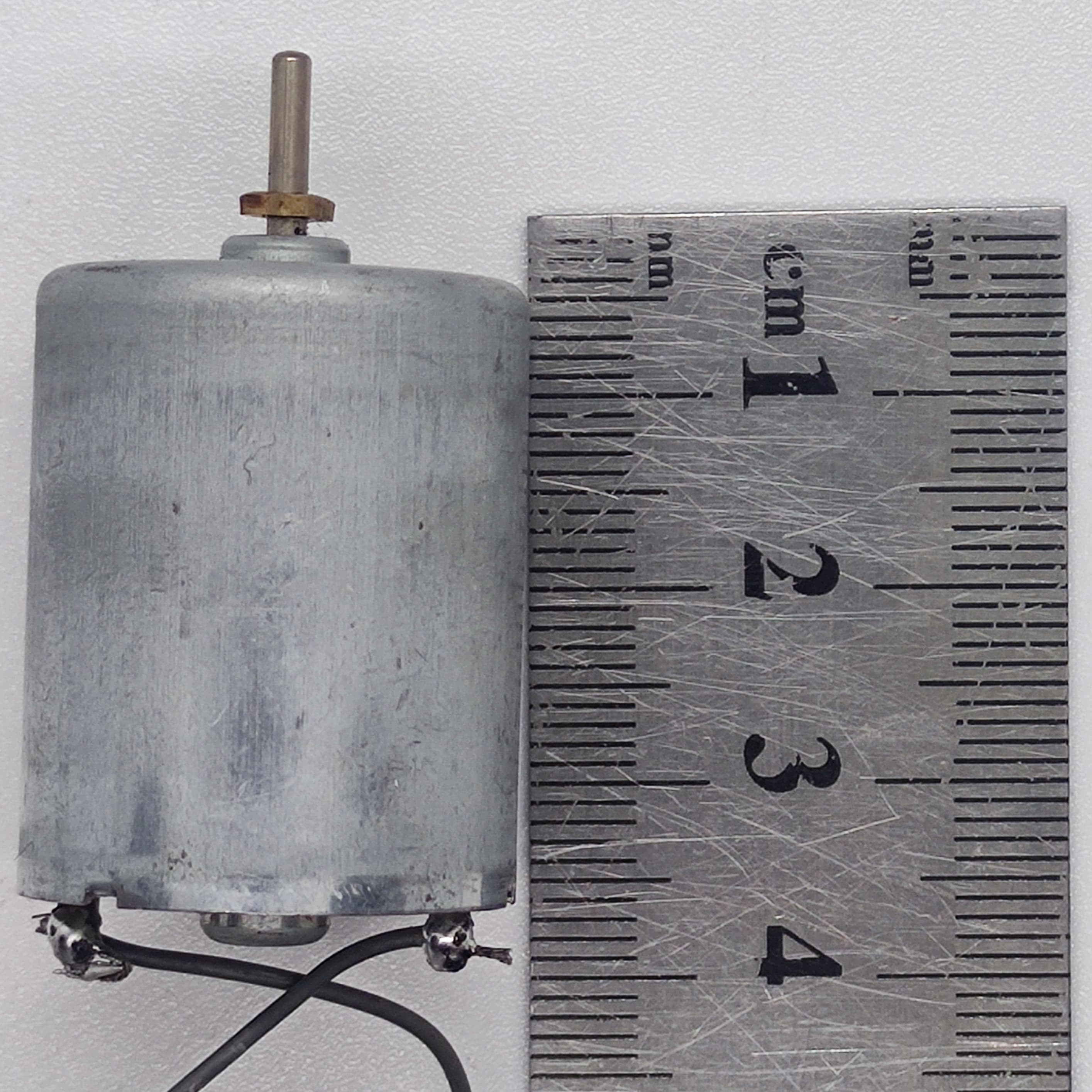 DC 2V To 24V 5100 RPM High Torque Mini Micro Motor DC Motor - shown as a silver cylindrical motor with a metal shaft next to a metal ruler for size reference.